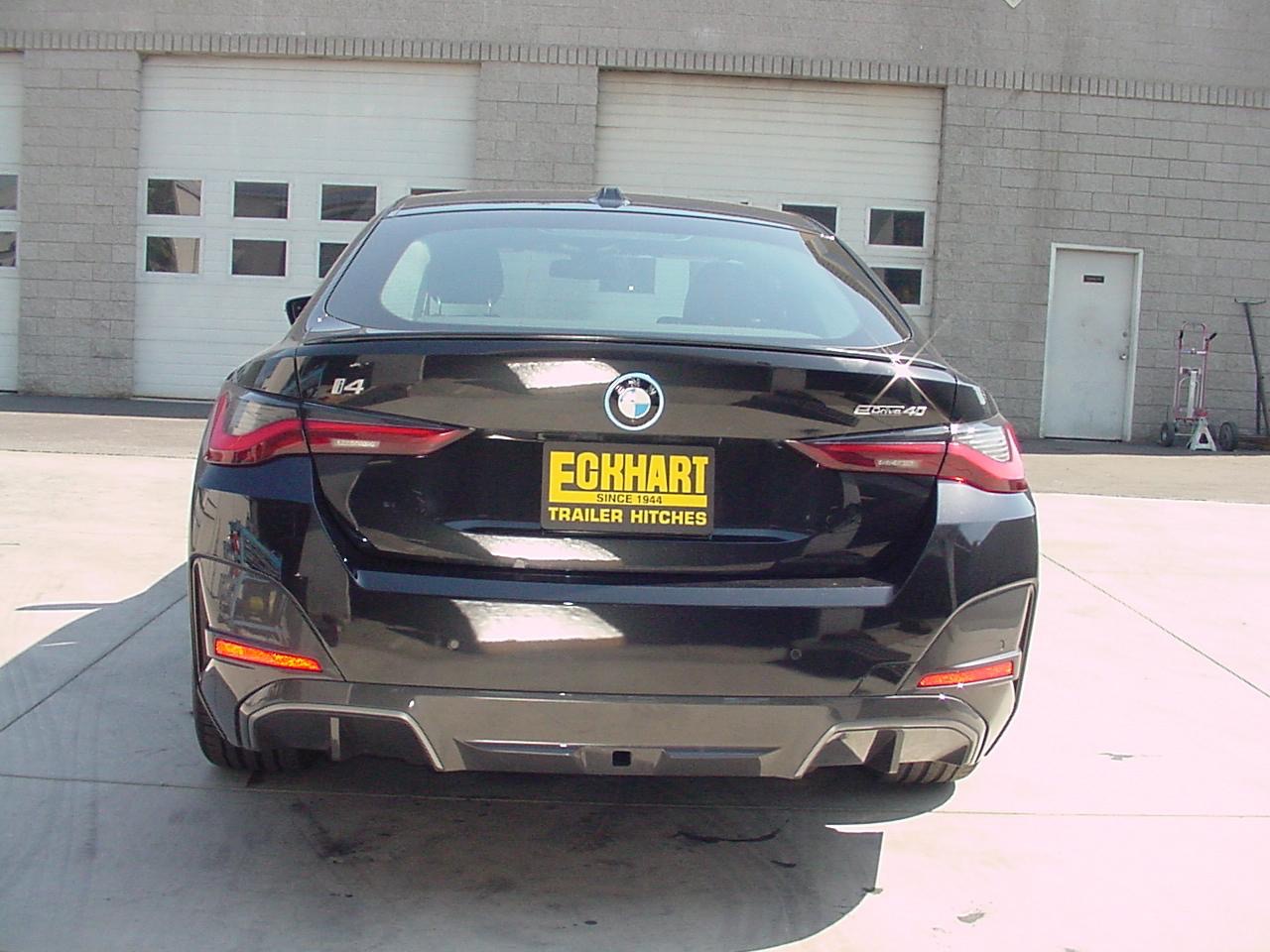 Custom hidden trailer hitch installed on a BMW I4 by the Eckharts welding team in Oxnard, CA.