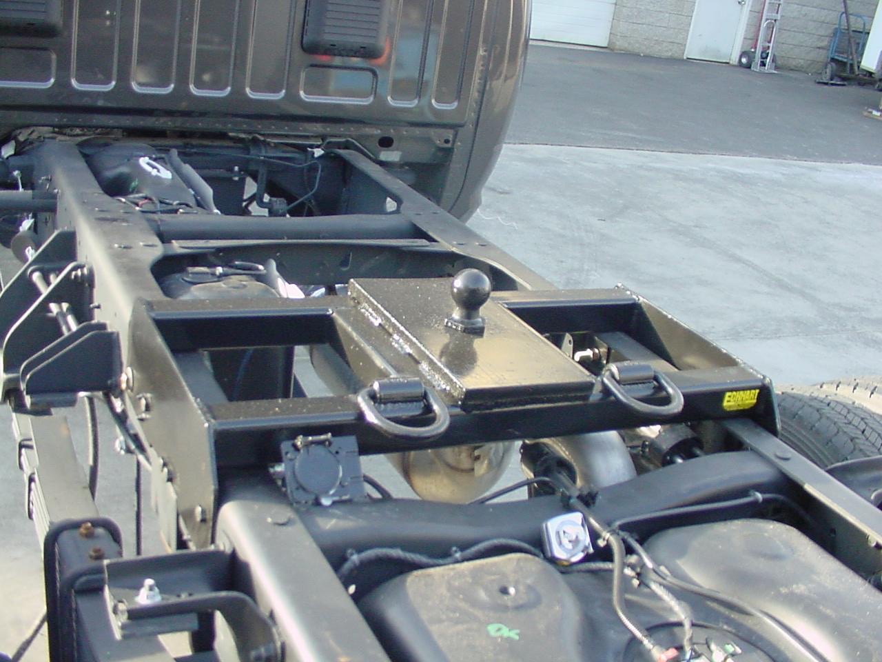 Heavy-duty gooseneck hitch installed on a commercial cab and chassis truck.
