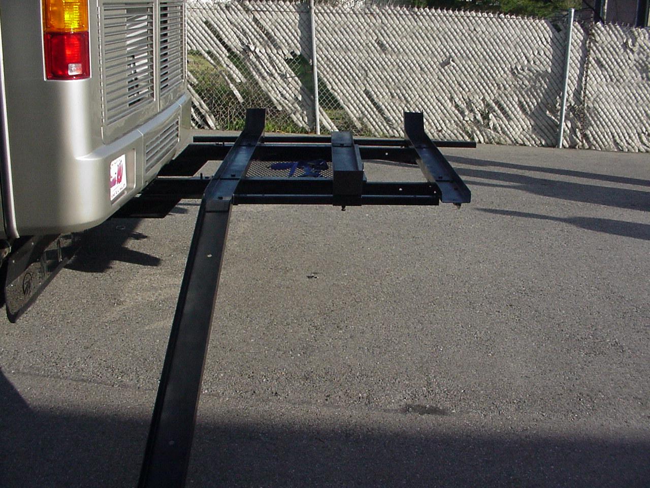 Eckharts custom-welded 3-motorcycle carrier rack mounted securely to a vehicle hitch.