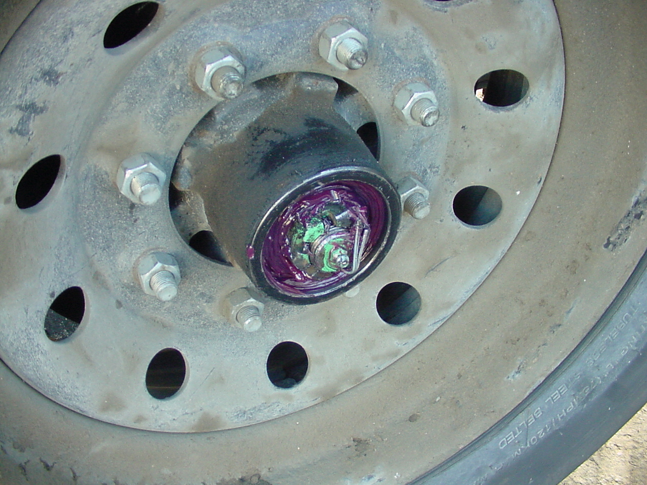 Eckharts technician packing fresh grease into trailer wheel bearings for safe towing.