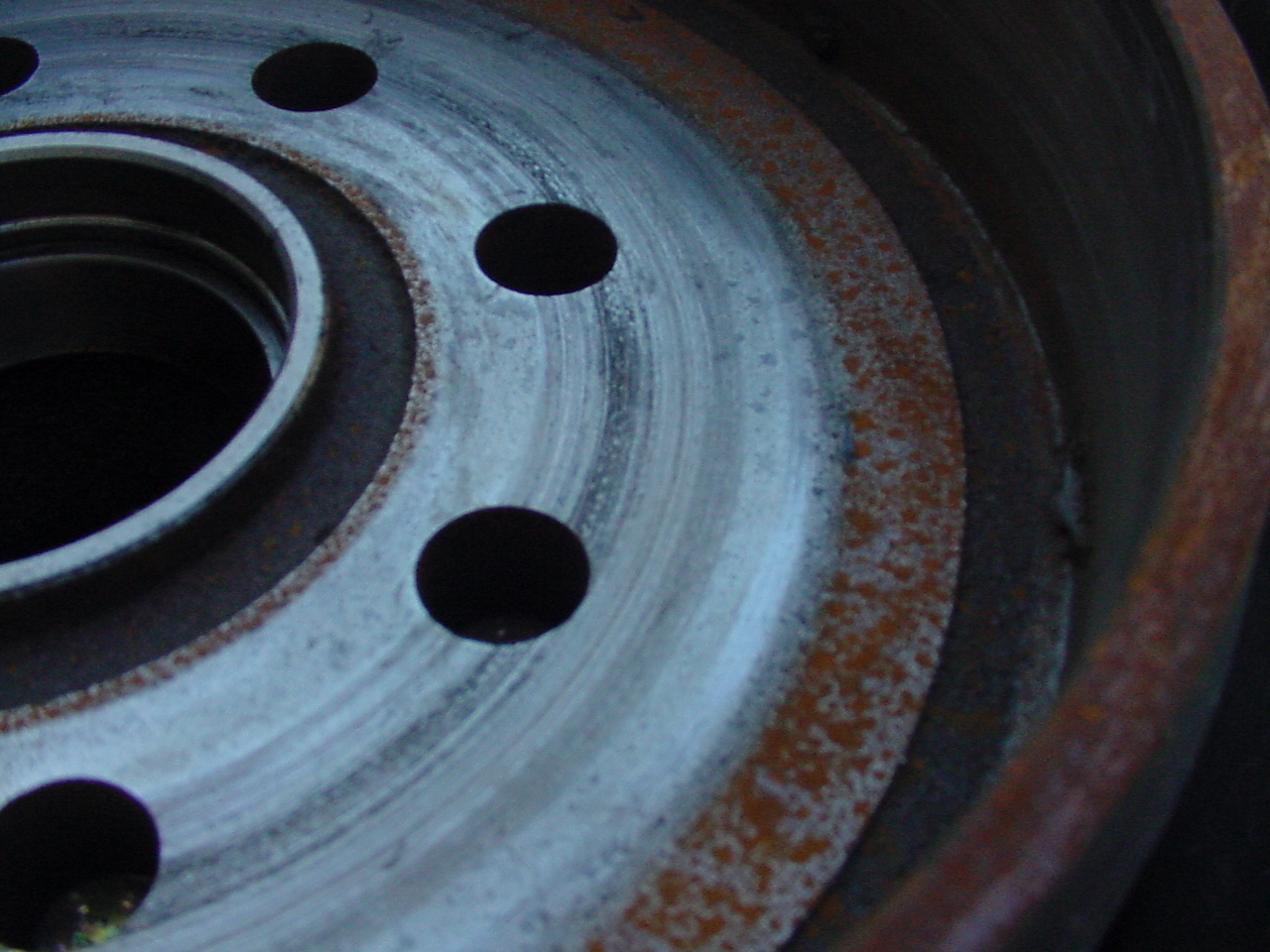 Inspection of a trailer brake inner drum surface for wear and damage.